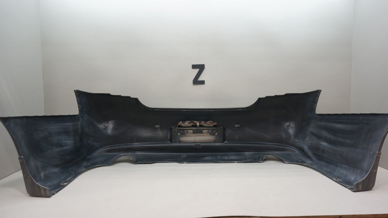 2009-2013 INFINITI G37 SEDAN REAR BUMPER COVER PANEL OEM